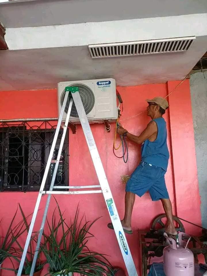 NJ Aircon Services technician performing refrigerant pressure check on Koppel inverter unit in Alabel, Sarangani Province